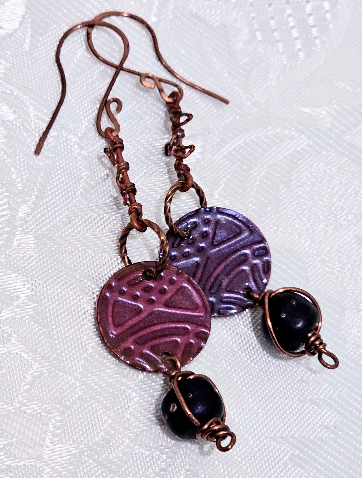 Suspended Pressed Metal Discs with Barbed Wirework Link and Black Matt Lampwork bead