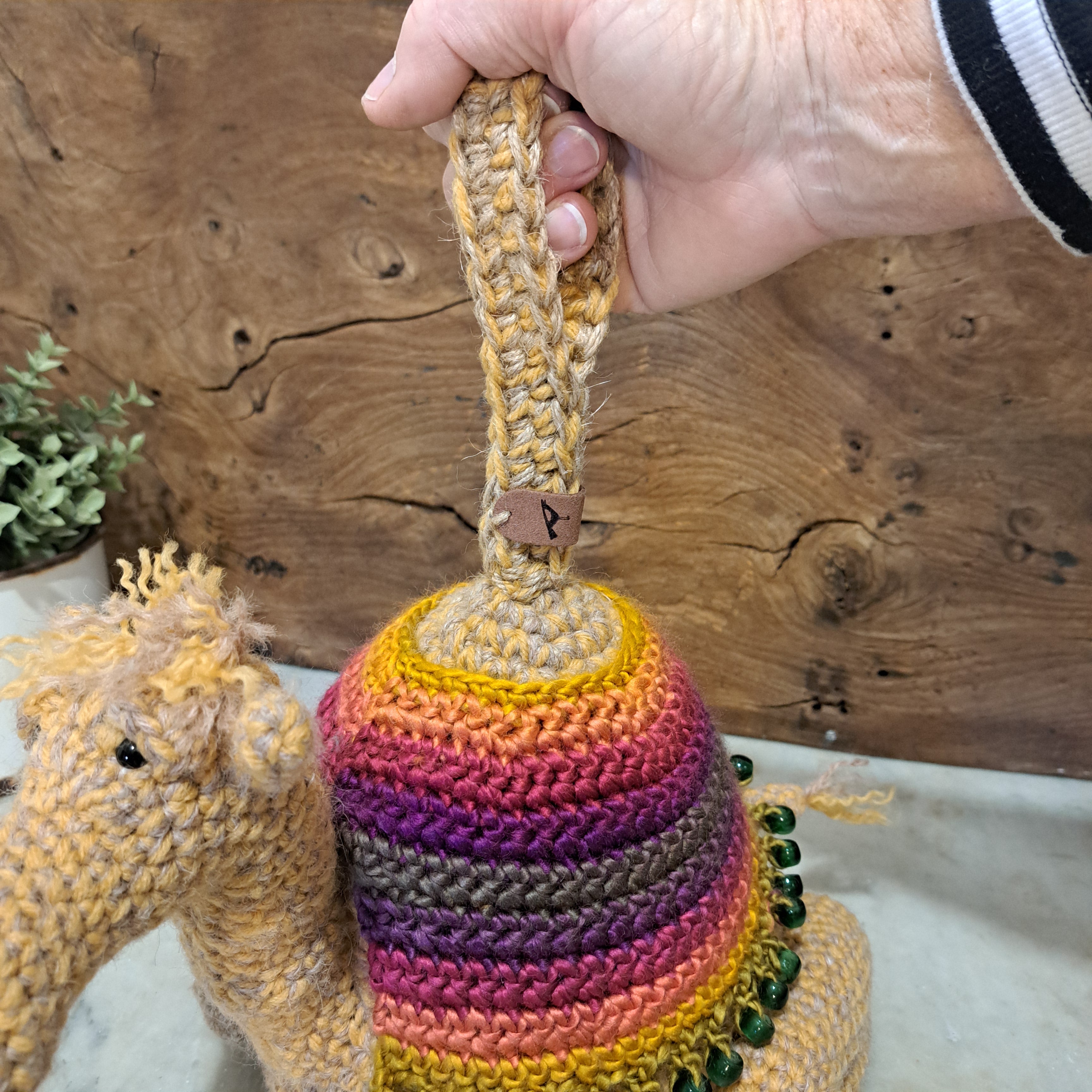 Handmade crochet camel doorstop colourful coat mustard coloured base