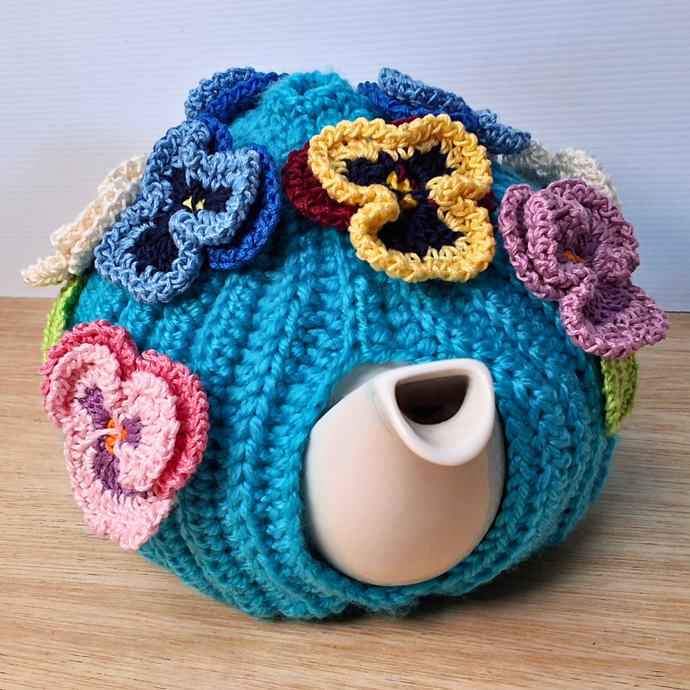 Pansies on a sea of bright blue Medium Teacosy