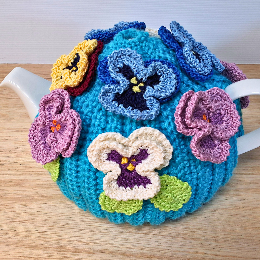 Pansies on a sea of bright blue Medium Teacosy