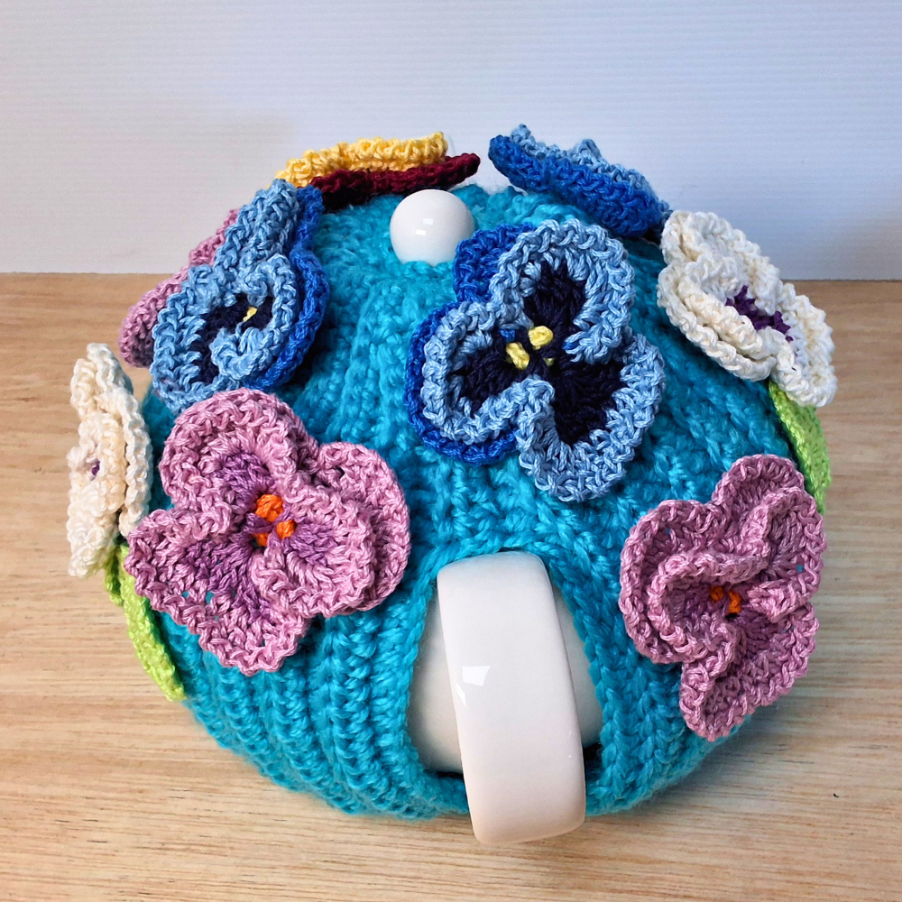 Pansies on a sea of bright blue Medium Teacosy