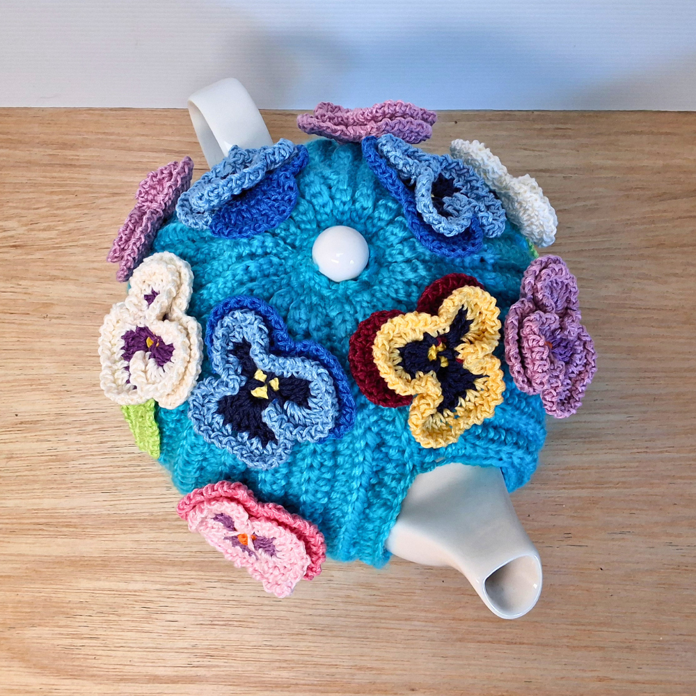 Pansies on a sea of bright blue Medium Teacosy