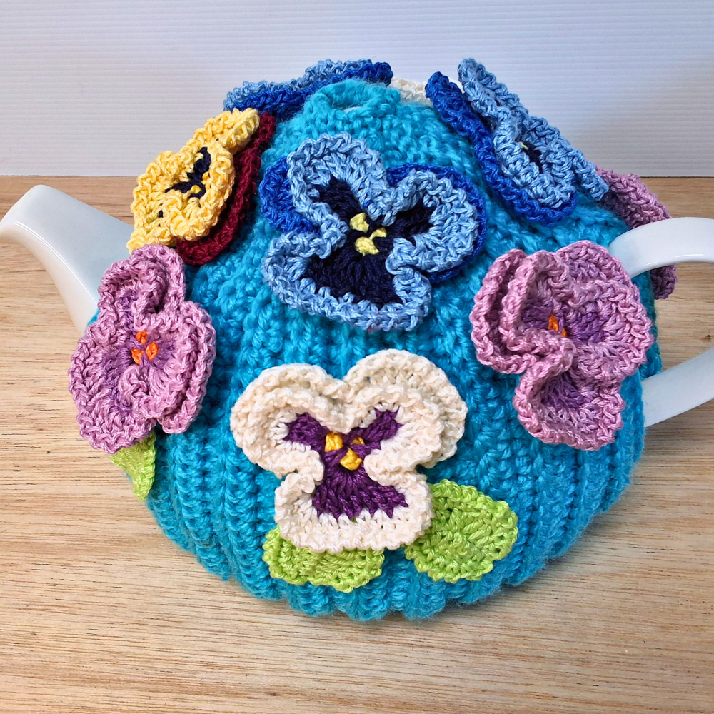 Pansies on a sea of bright blue Medium Teacosy