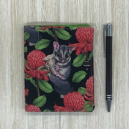 Possums refillable fabric pocket notepad cover with snap closure. Incl. book and pen.