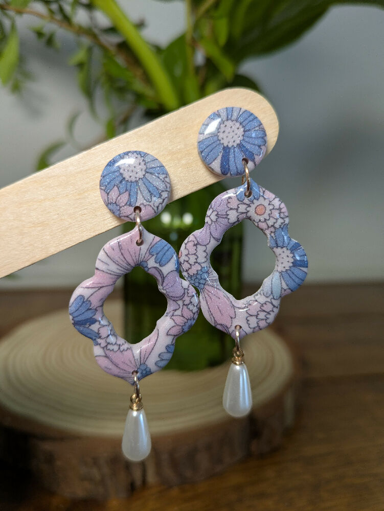 Blue flower earrings with faux pearl drop close up