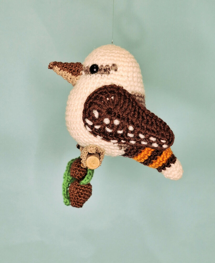 Crocheted laughing Kookaburra room decoration on perch