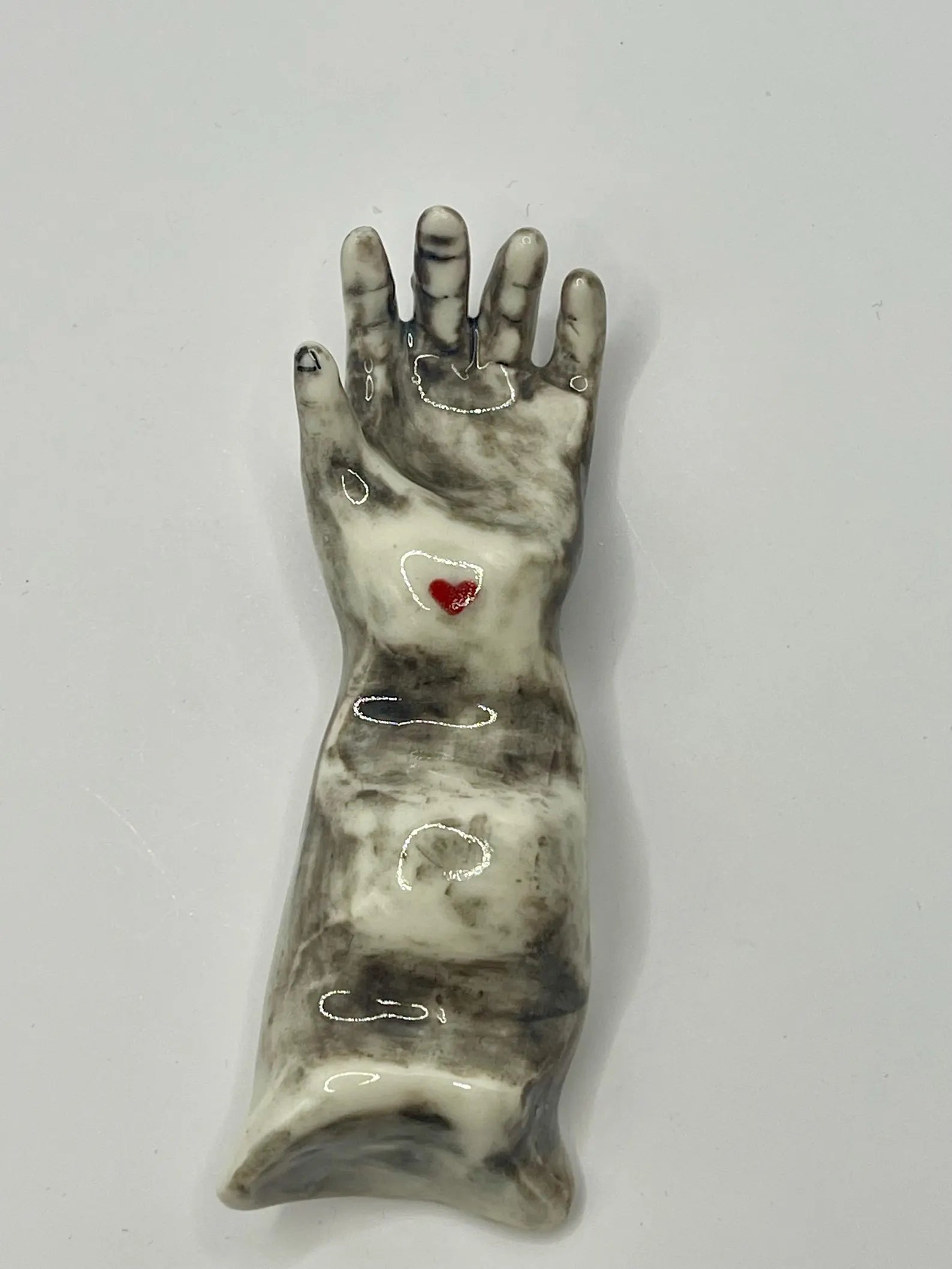 Handmade porcelain ‘helping hand’ brush rest