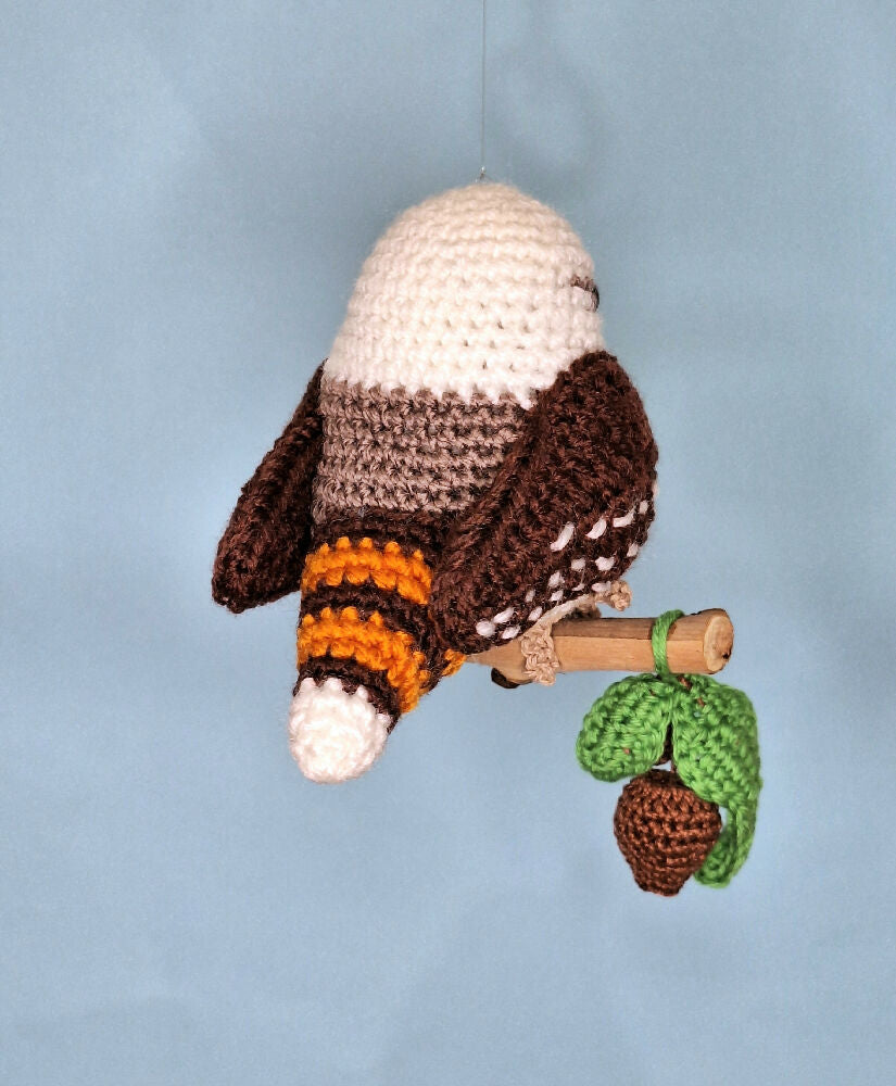 Crocheted laughing Kookaburra room decoration on perch