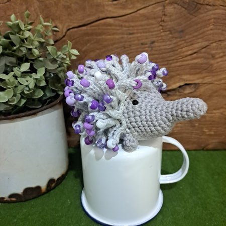 Handmade crochet echidna in grey cotton with mauve beads