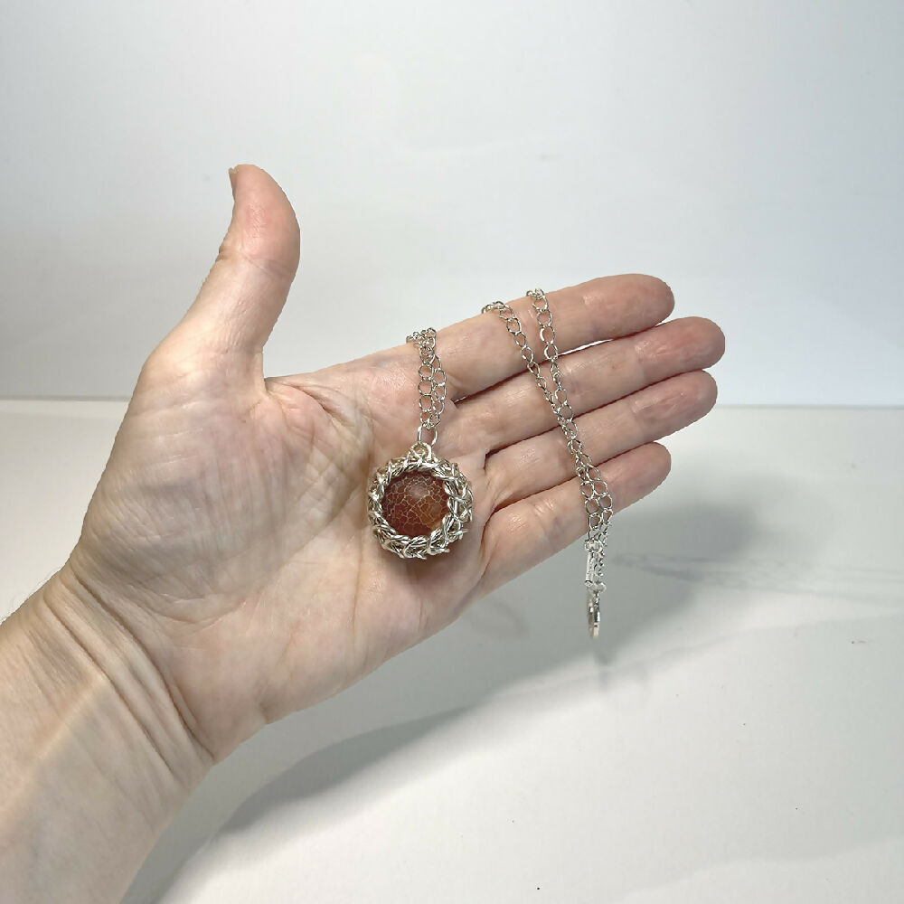 Caged fire agate pendant hand