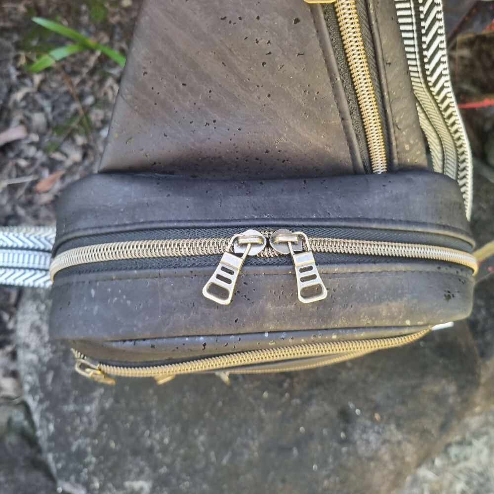 Black cork sling bag, top view showing double zip closure.