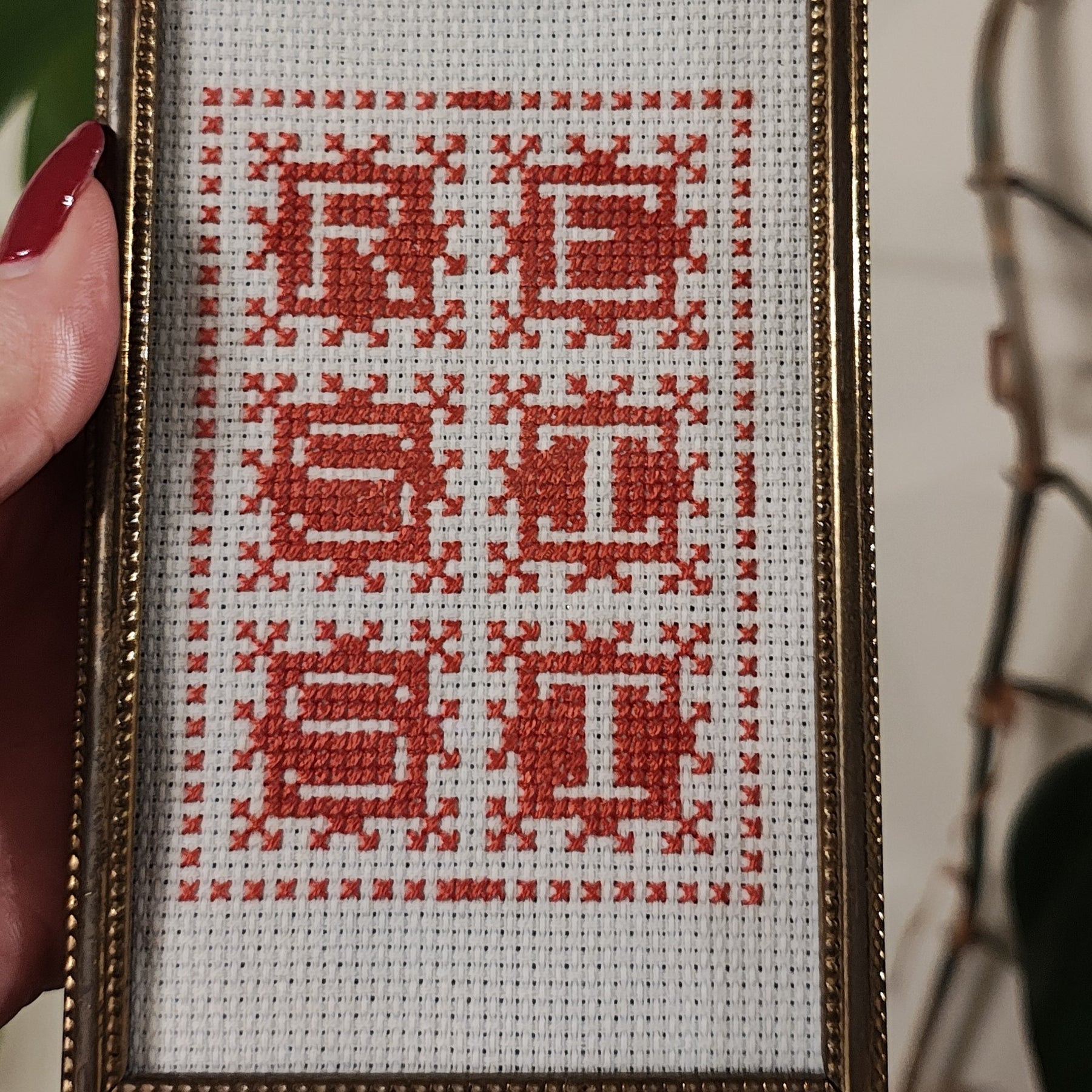 "RESIST" framed cross-stitch