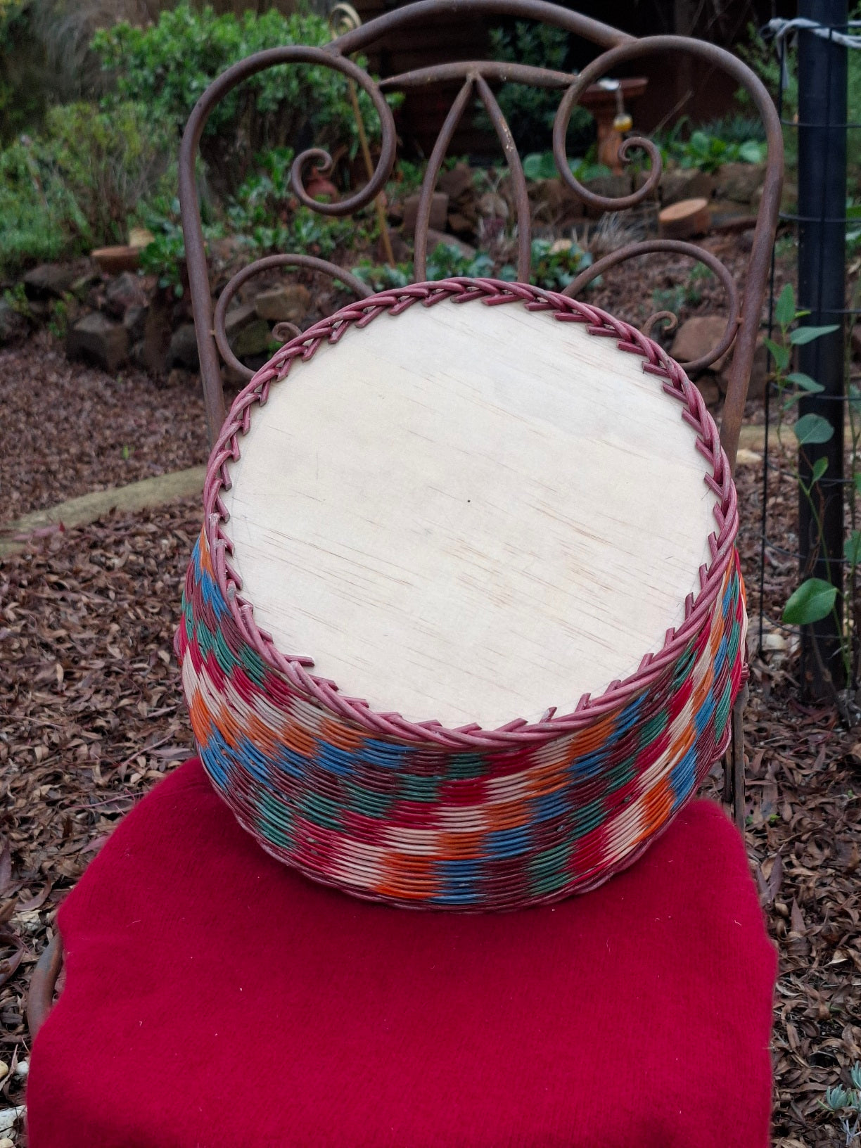 Large Round Market Basket brown, blue, orange, red and natural. Handle brown.