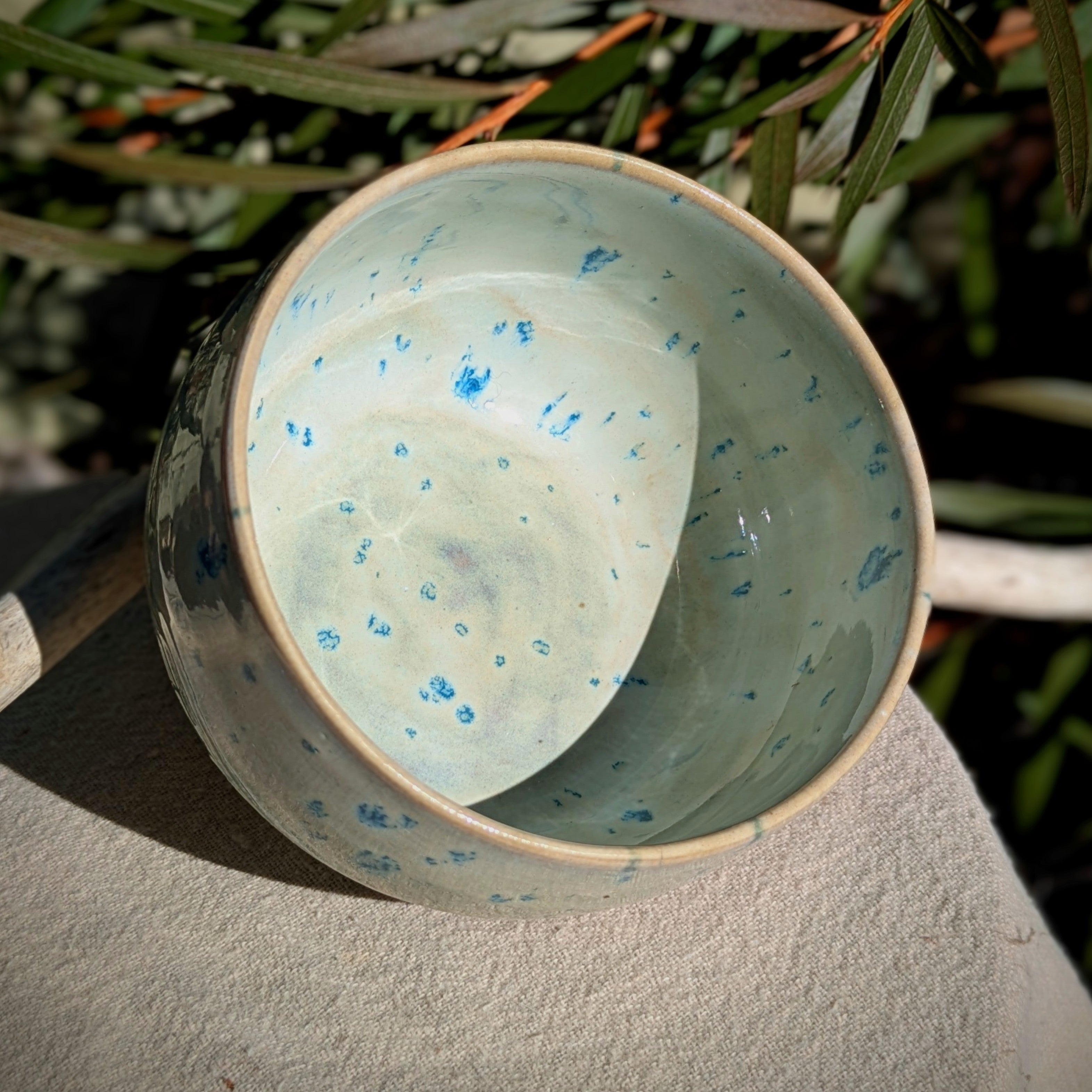 Small bowl in moss green and cream with blue speckles