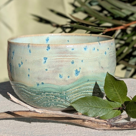 Small bowl in moss green and cream with blue speckles