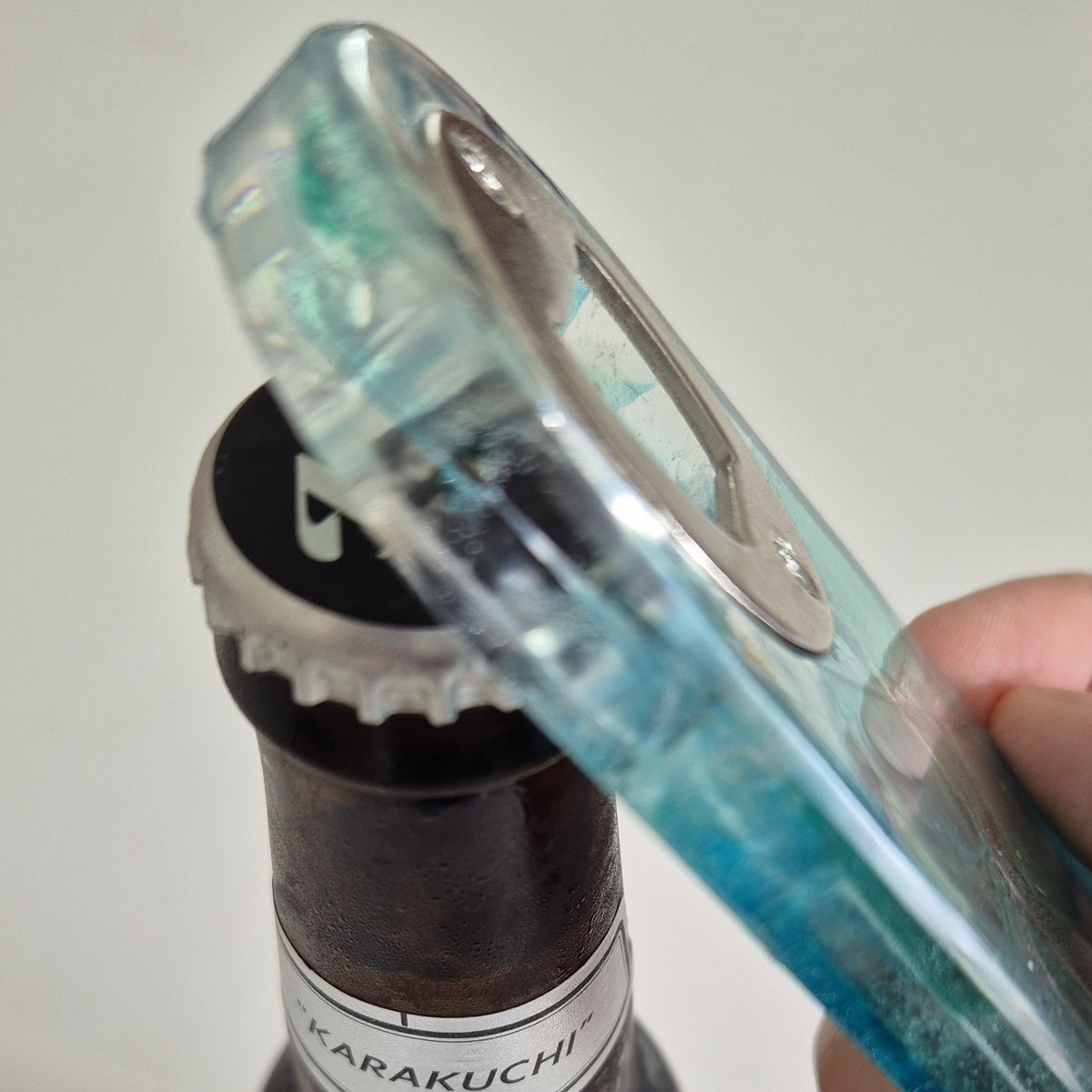 Resin bottle opener with inlaid sea glass
