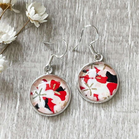 Statement earrings with a black, white, gold and red pattern