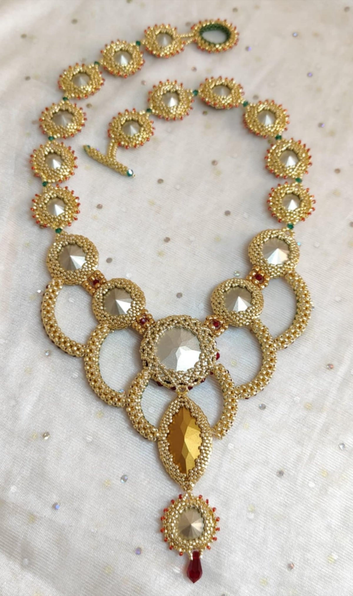 Bead-woven statement necklace with red/green crystal accents