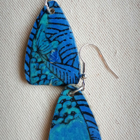 Azure blue ceramic teardrop shaped earrings with hints of teal and fish design