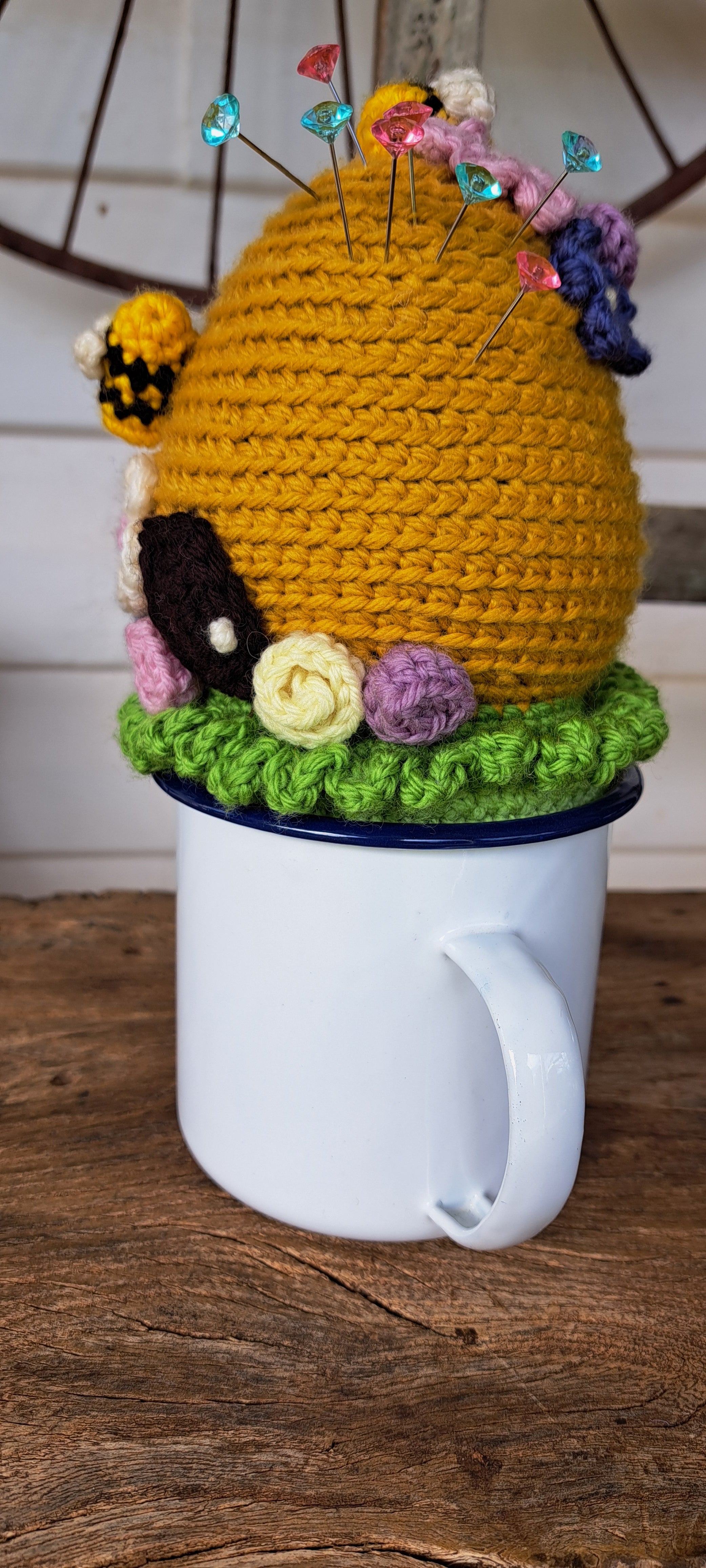 Beehive pin cushion in a sturdy enamel tin mug