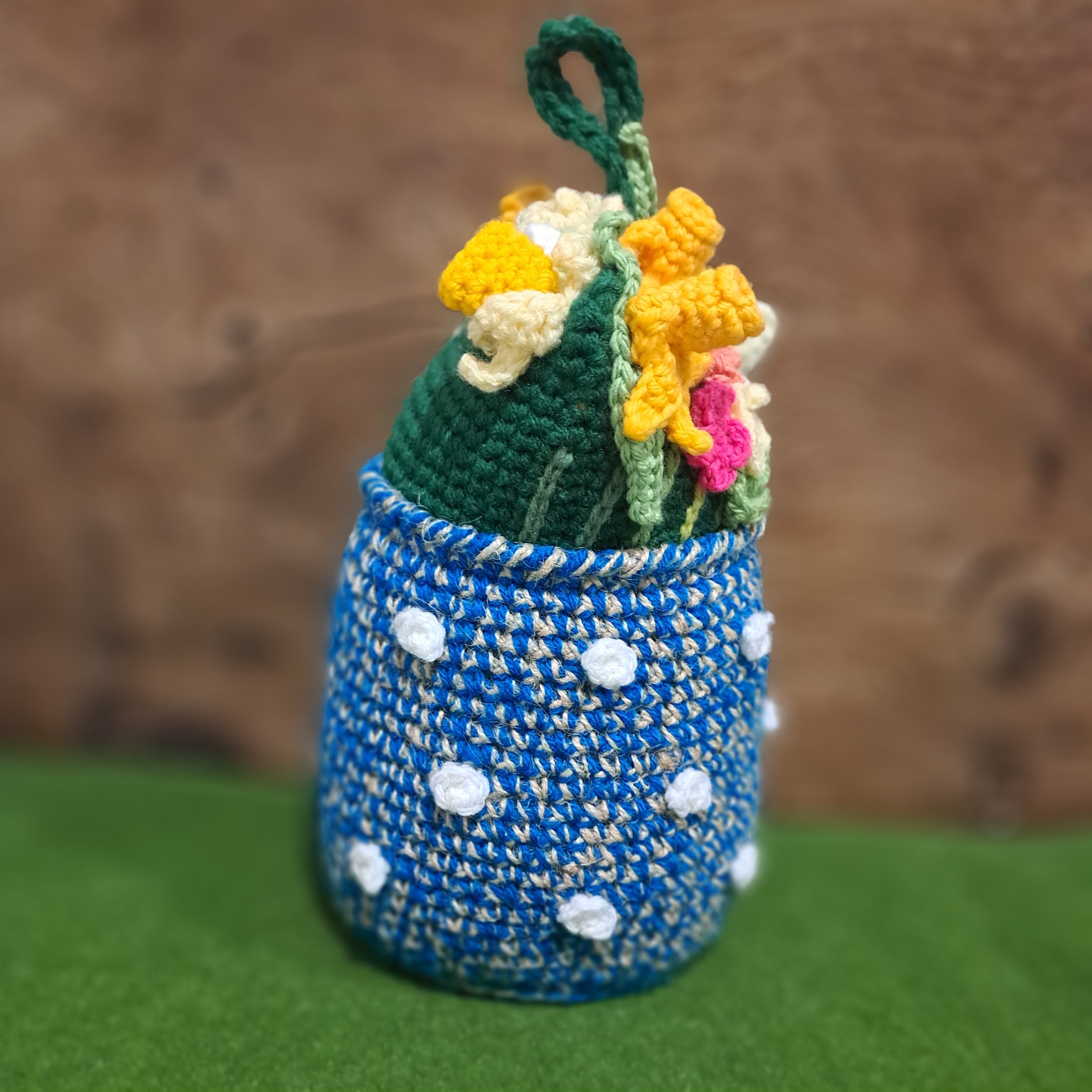 Doorstop vase of crochet spring flowers.
