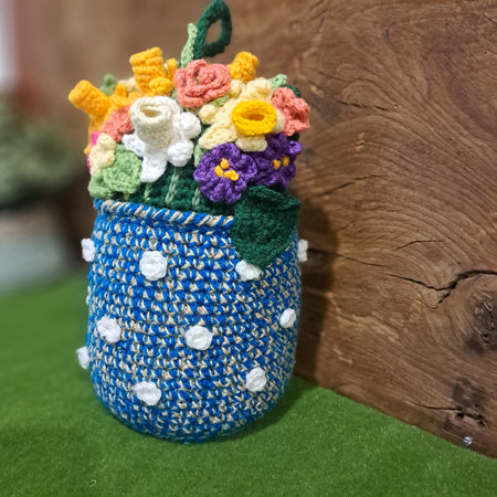Doorstop vase of crochet spring flowers.