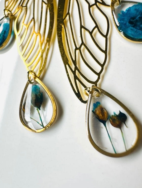 Butterfly resin earring with blue pressed flowers