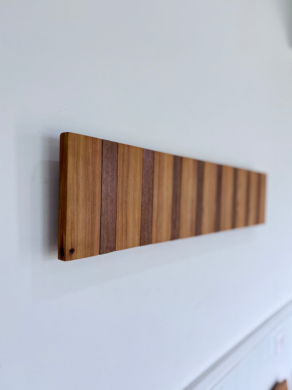 Two tone spotted gum and cypress horizon line piano style coatrack