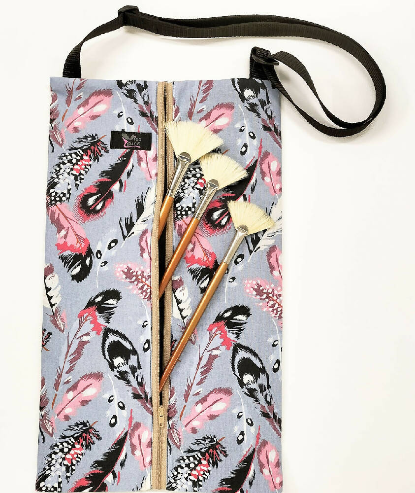 Feather print waterproof bag with adjustable strap. Toiletry bag