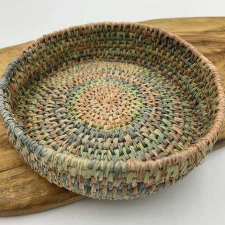 Raffia basket in pastel shades of pink, blue and green