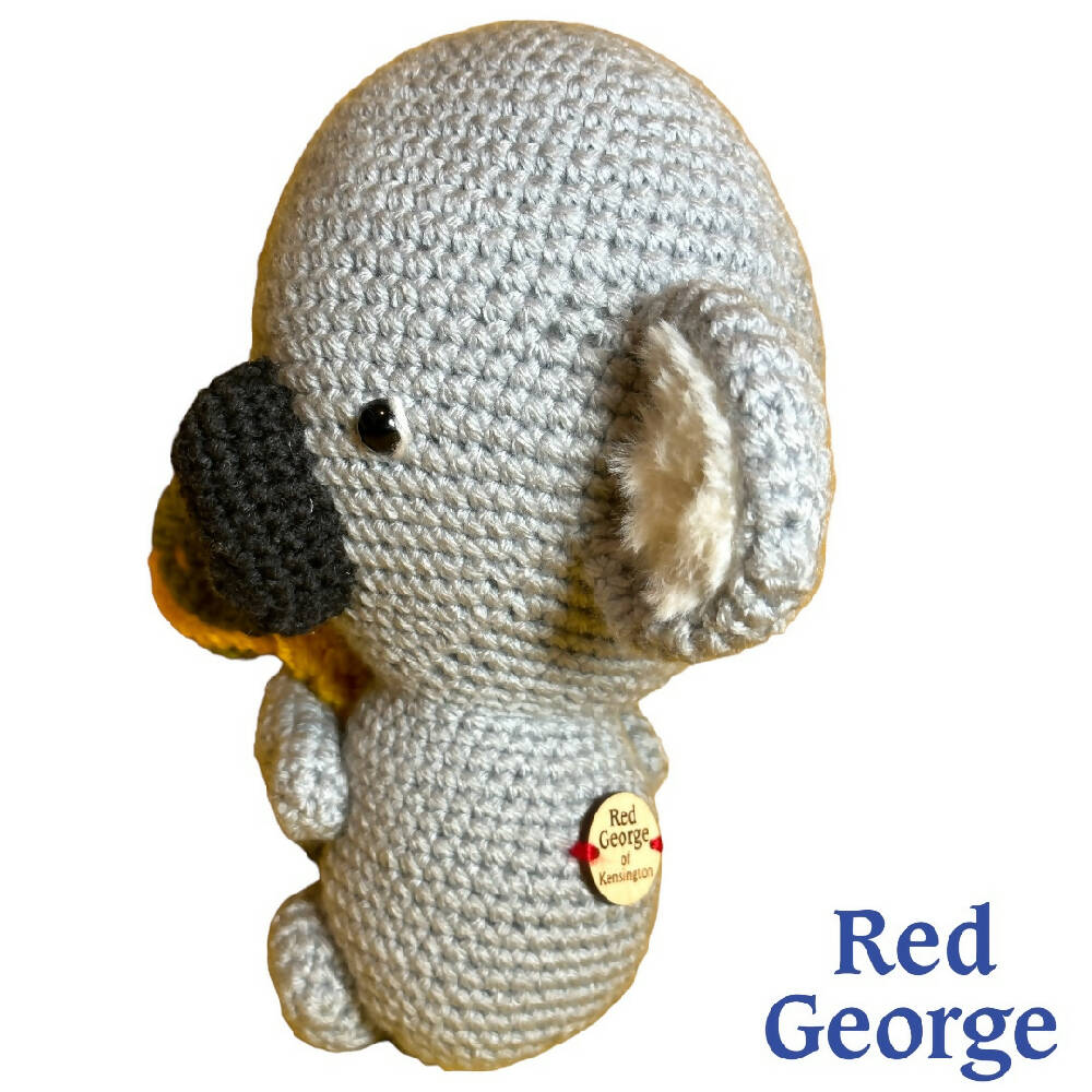 Red George of Kensington crochet toy Koala hugging a green & yellow blanket