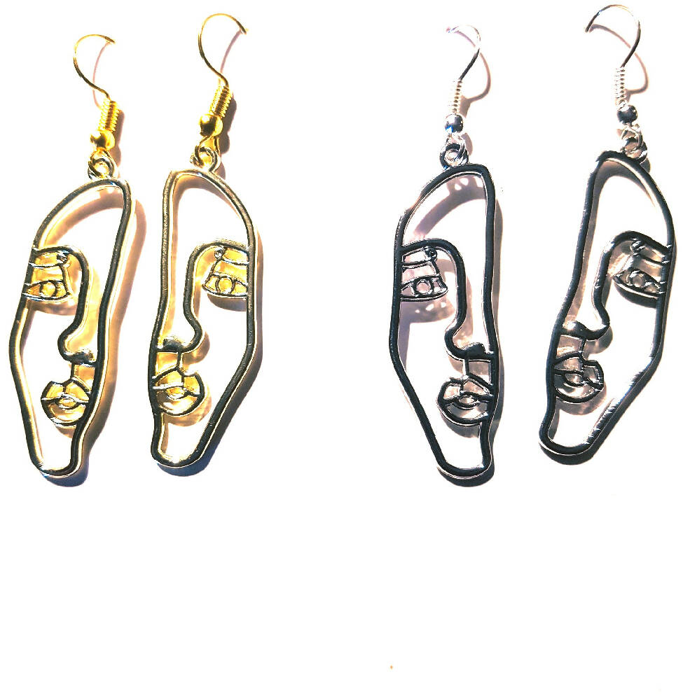 Dangle earrings. Face silhouette in gold or silver.