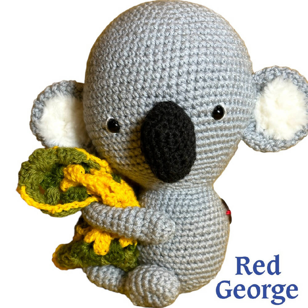 Red George of Kensington crochet toy Koala hugging a green & yellow blanket