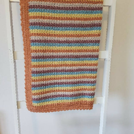 Multi coloured crochet blanket.