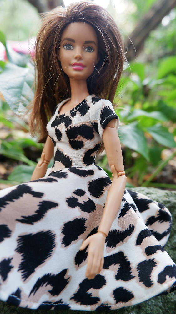 Photo of barbie in leopard print dress sitting