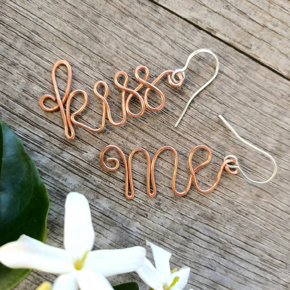 handmade kiss me earrings in copper and silver with white flower