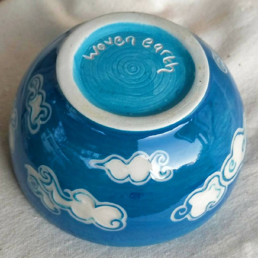 Blue sky, white clouds. Small hand made condement bowl