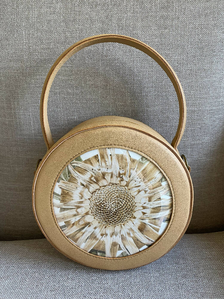 Round hand-made leather handbag featuring ‘Protea’ artwork