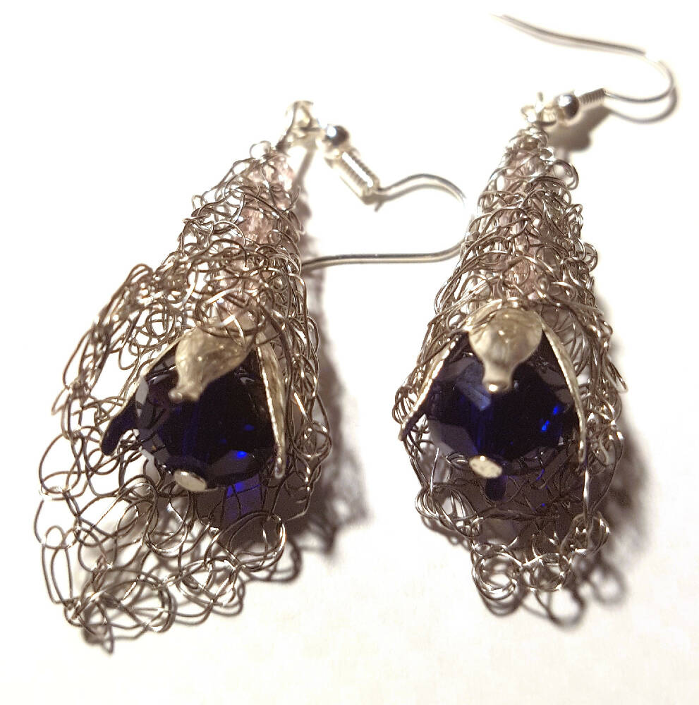 Dangle earring, silver crochet wire with blue crystal.