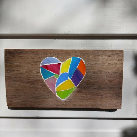 Colourful stained glass heart mosaic carved into reclaimed wood