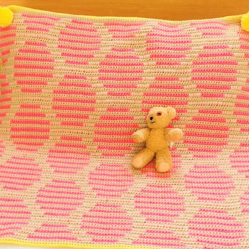 Baby hand made neon pink dot blanket trimmed in bright lemon with pompoms.