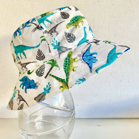 Summer hat in blue & green dinosaur fabric