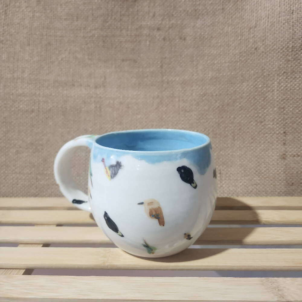 blue glazed porcelain birb doodle mug, handmade in tassie