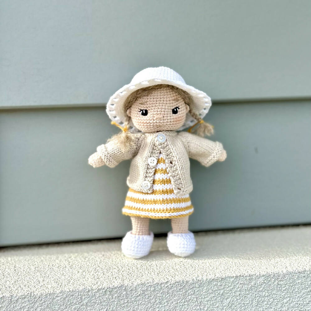 Australian handmade crochet doll Ruby wearing a sun hat and yellow dress