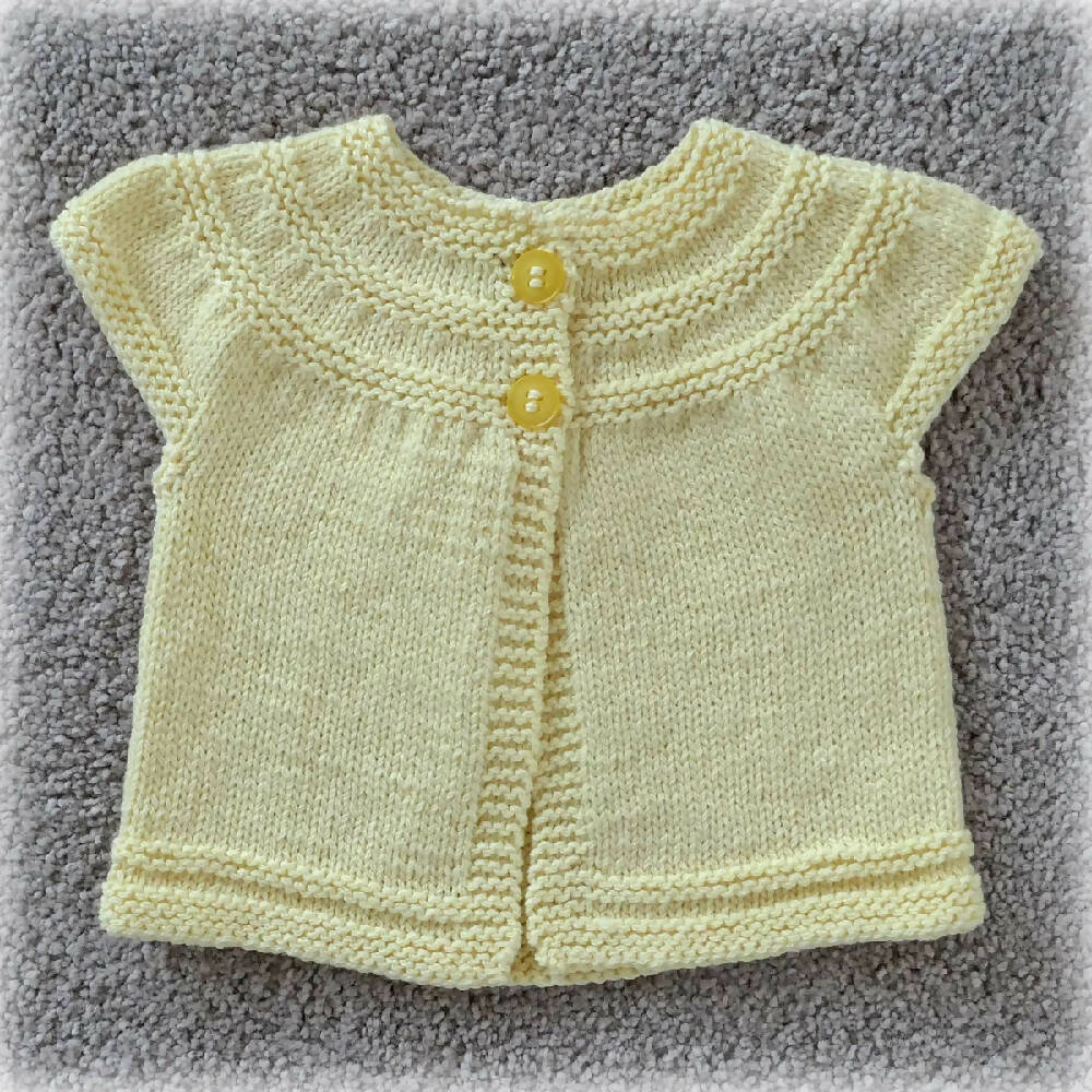 Baby /toddler cardigan with circular yoke and short sleeves.