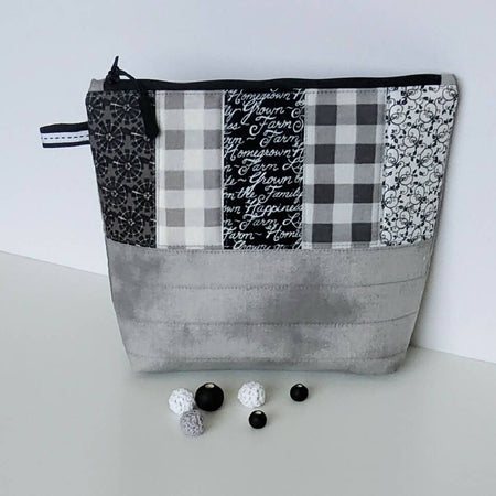 Grey, black and white zippered pouch.
