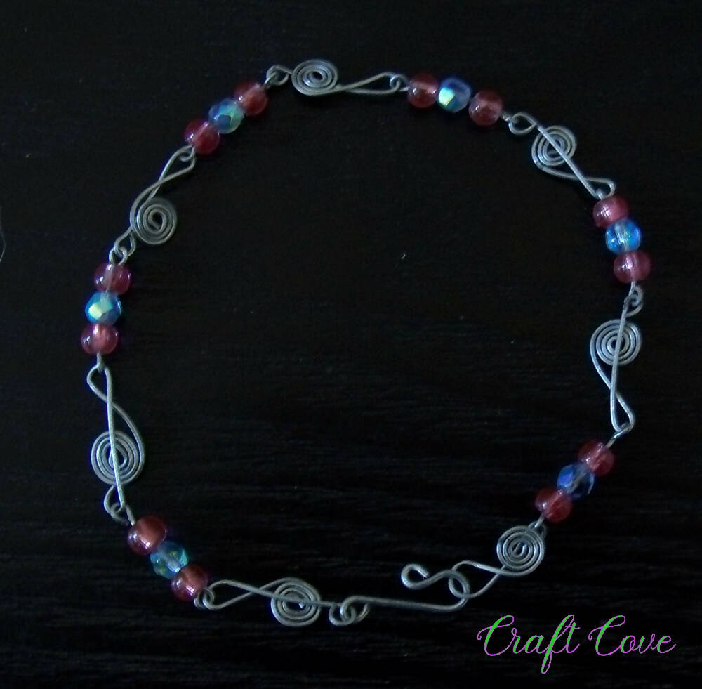 Bracelet wire worked with music shapes and beads