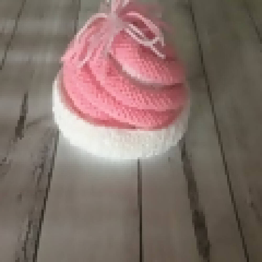 Pink and white knitted beanie and ugg booties.