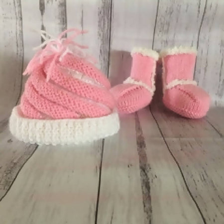 Pink and white knitted beanie and ugg booties.