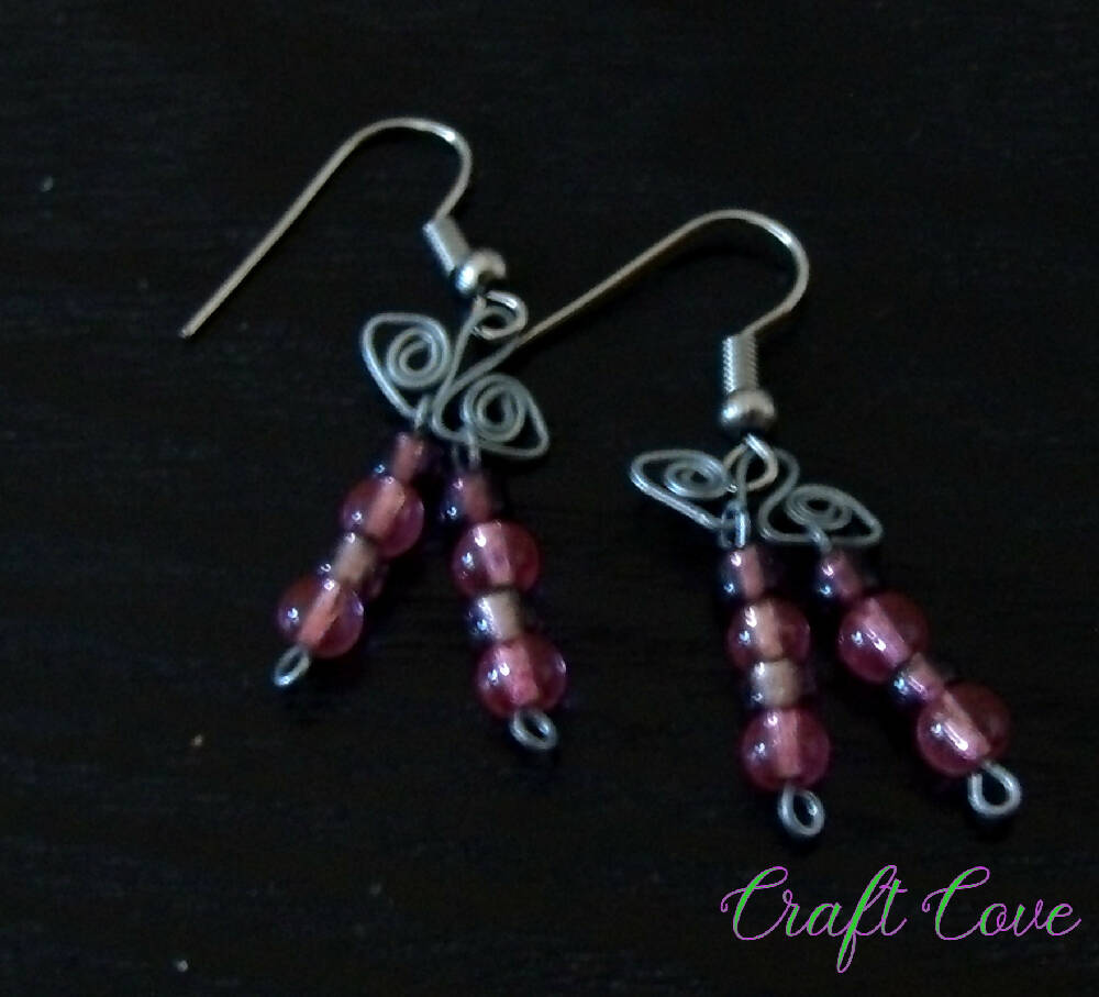 Earrings wire worked in Squiggly shapes with beads